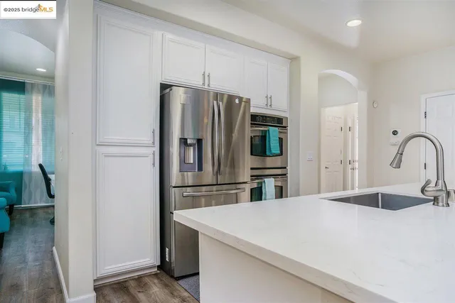 a kitchen with stainless steel appliances a refrigerator and a stove
