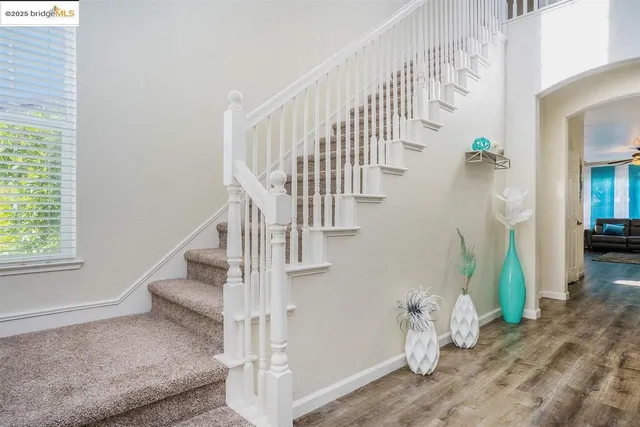 a view of entryway and hall with wooden floor