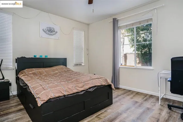 a bedroom with a bed and a window