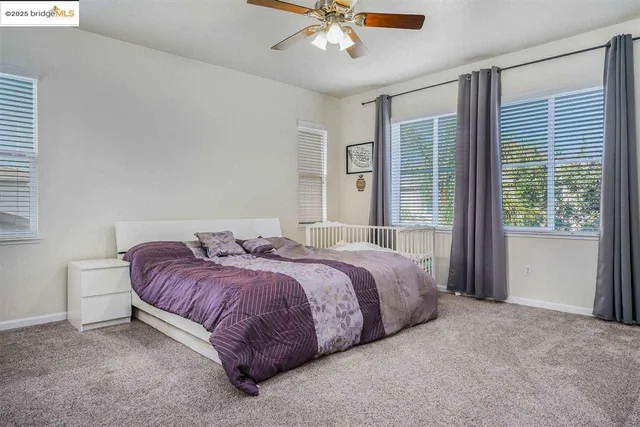 a spacious bedroom with a bed and window