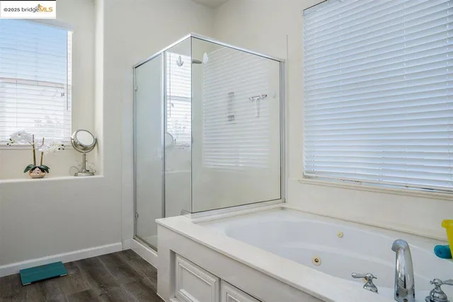 a bathroom with a bathtub and shower