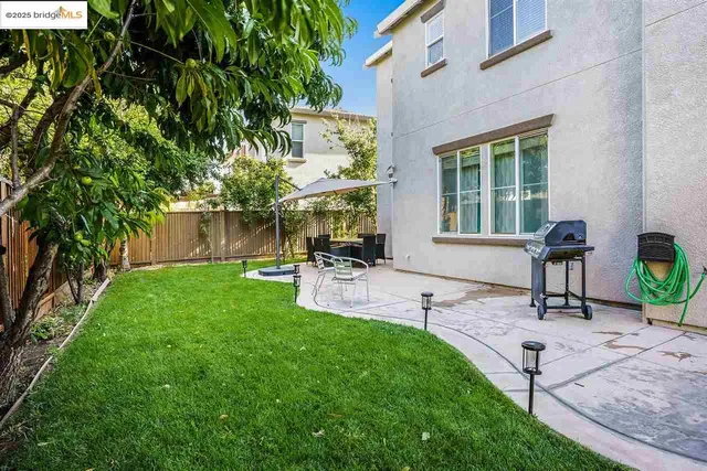 a house view with a sitting space and garden