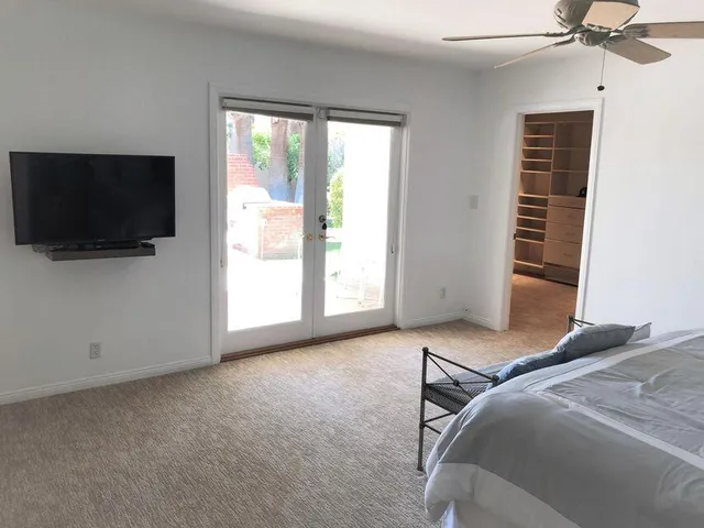 a bedroom with a bed and a flat screen tv