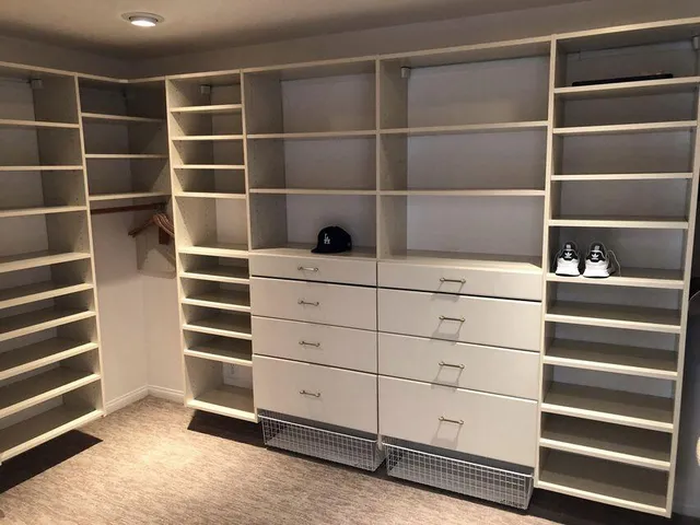 a view of walk in closet with empty racks
