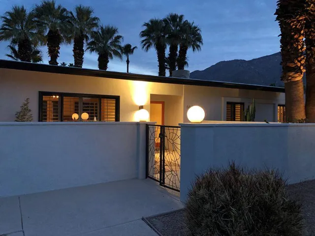 a view of a house with a swimming pool and a yard
