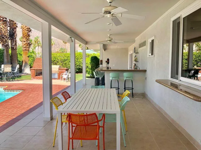 a view of a dining room with furniture a chandelier and wooden floor