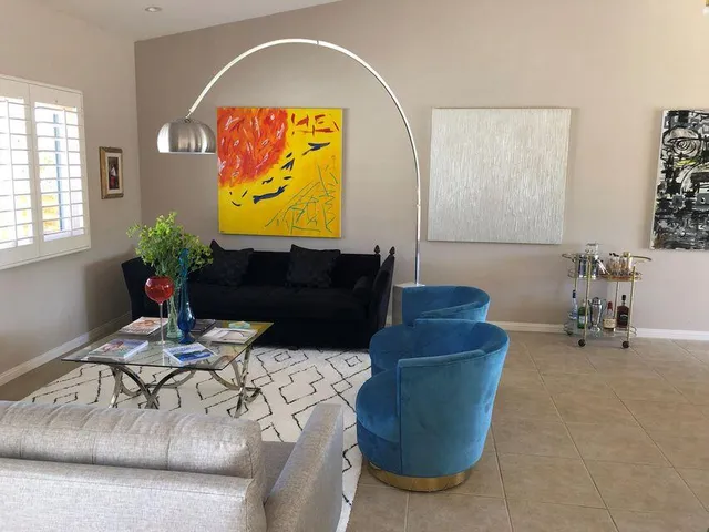 a living room with furniture and a potted plant