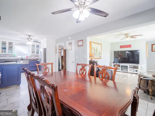 a large kitchen with kitchen island a large counter top space appliances and cabinets