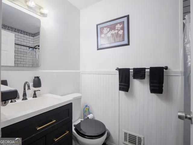 a kitchen with granite countertop a sink stainless steel appliances and cabinets