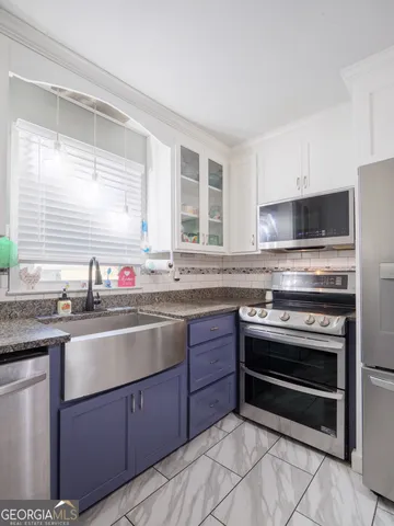 a spacious bedroom with a bed and a chandelier