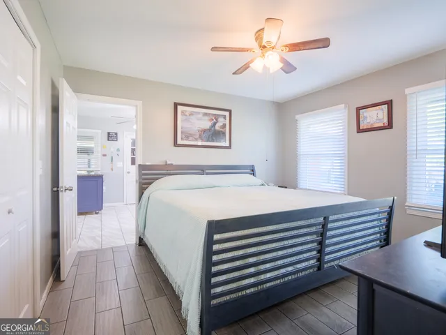 a spacious bedroom with a bed and a chandelier