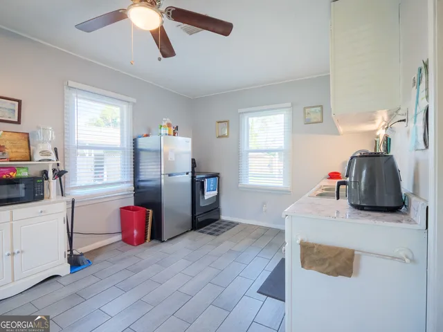 a bedroom with a bed a dresser and flat screen tv