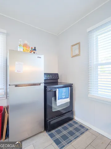 a view of a house with a yard and wooden fence