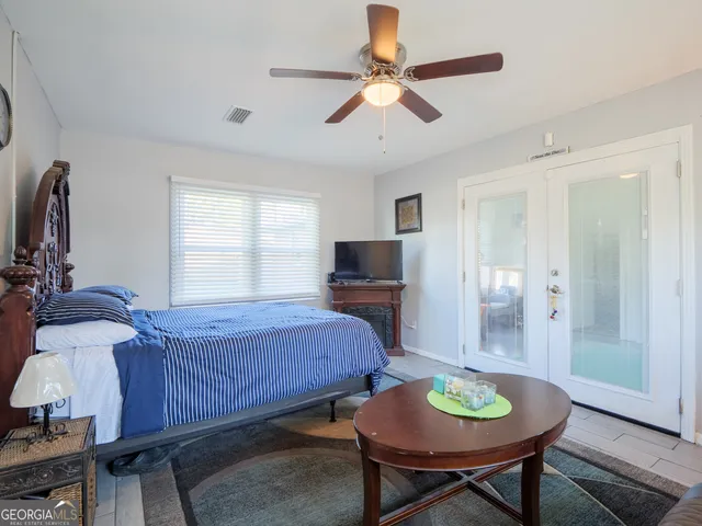 a view of a backyard with table and chairs under an umbrella