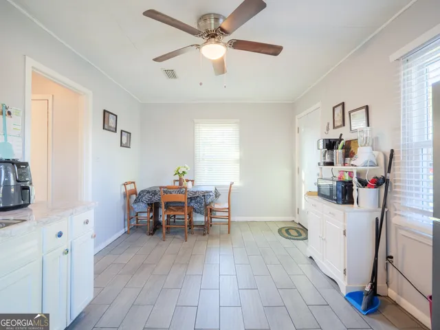 a view of a house with a big yard and large trees