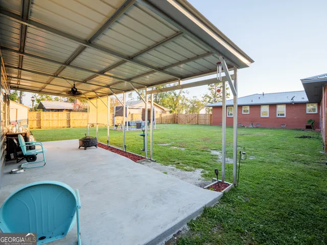 a view of a house with a yard and sitting area