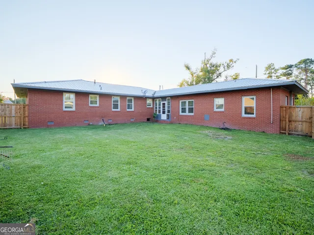 a view of a house with a backyard porch and furniture