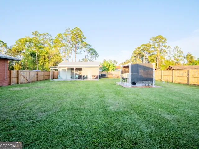 a view of a porch with furniture and a backyard