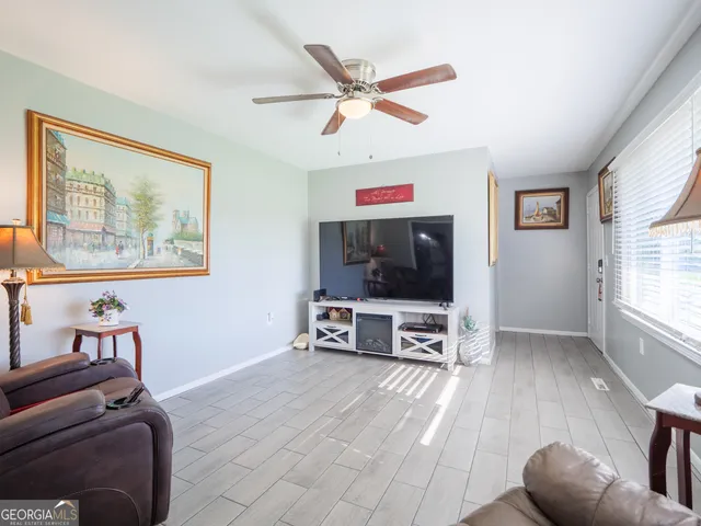 a living room with furniture and a flat screen tv
