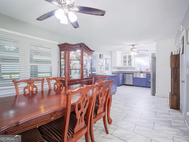 a view of a dining room with furniture and chandelier