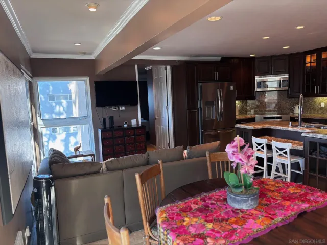 a kitchen with stainless steel appliances granite countertop a refrigerator and a stove