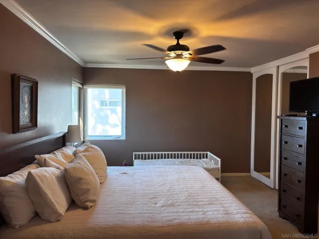 a bedroom with a bed and a tv