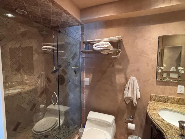 a bathroom with a sink toilet and shower