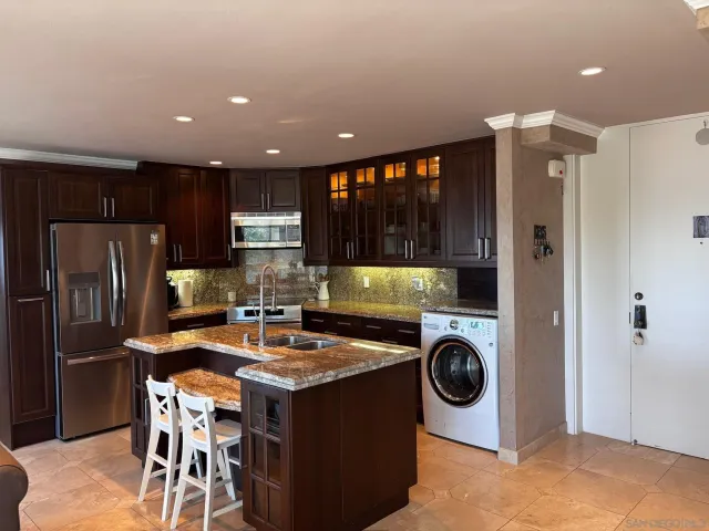 a kitchen with a refrigerator a stove and a wooden cabinets