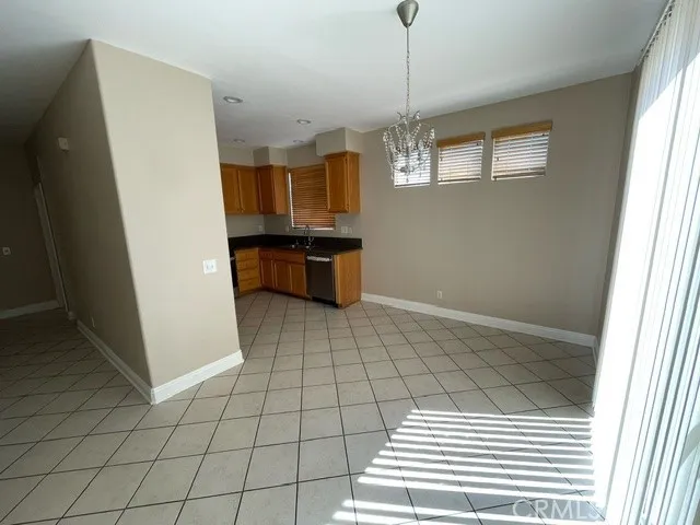 a view of kitchen with granite countertop cabinets and window