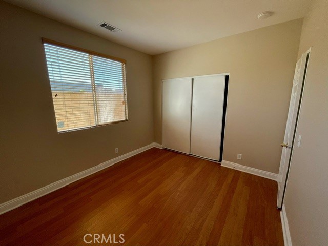 6212 Jasmine Way Cypress, CA 90630 - Photo 5 of 14 a view of an empty room with wooden floor and a window