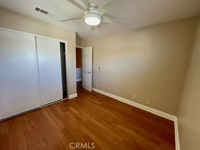 6212 Jasmine Way Cypress, CA 90630 - Photo 9 of 14 an empty room with a ceiling fan and wooden floor