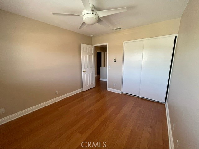 6212 Jasmine Way Cypress, CA 90630 - Photo 10 of 14 an empty room with wooden floor and a ceiling fan
