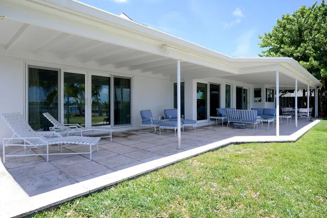 a view of a patio with table and chairs and potted plants