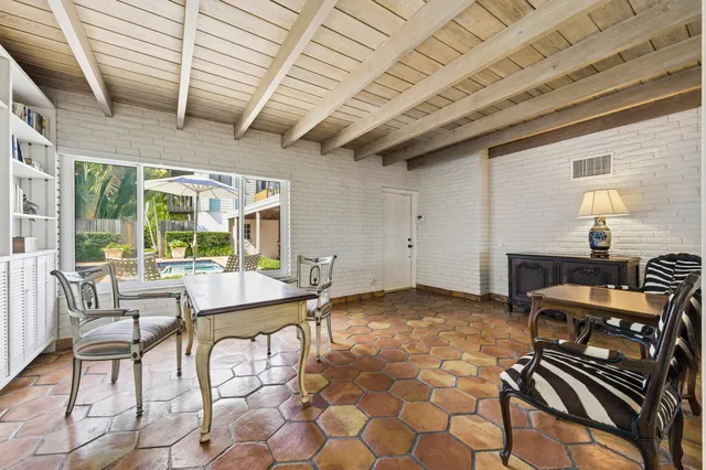 a living room with fireplace furniture and a potted plant