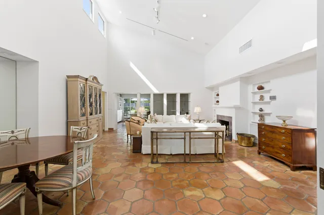 a large white kitchen with a stove top oven a sink and dishwasher