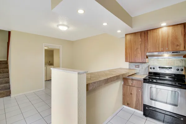 a bathroom with a granite countertop sink toilet and a mirror
