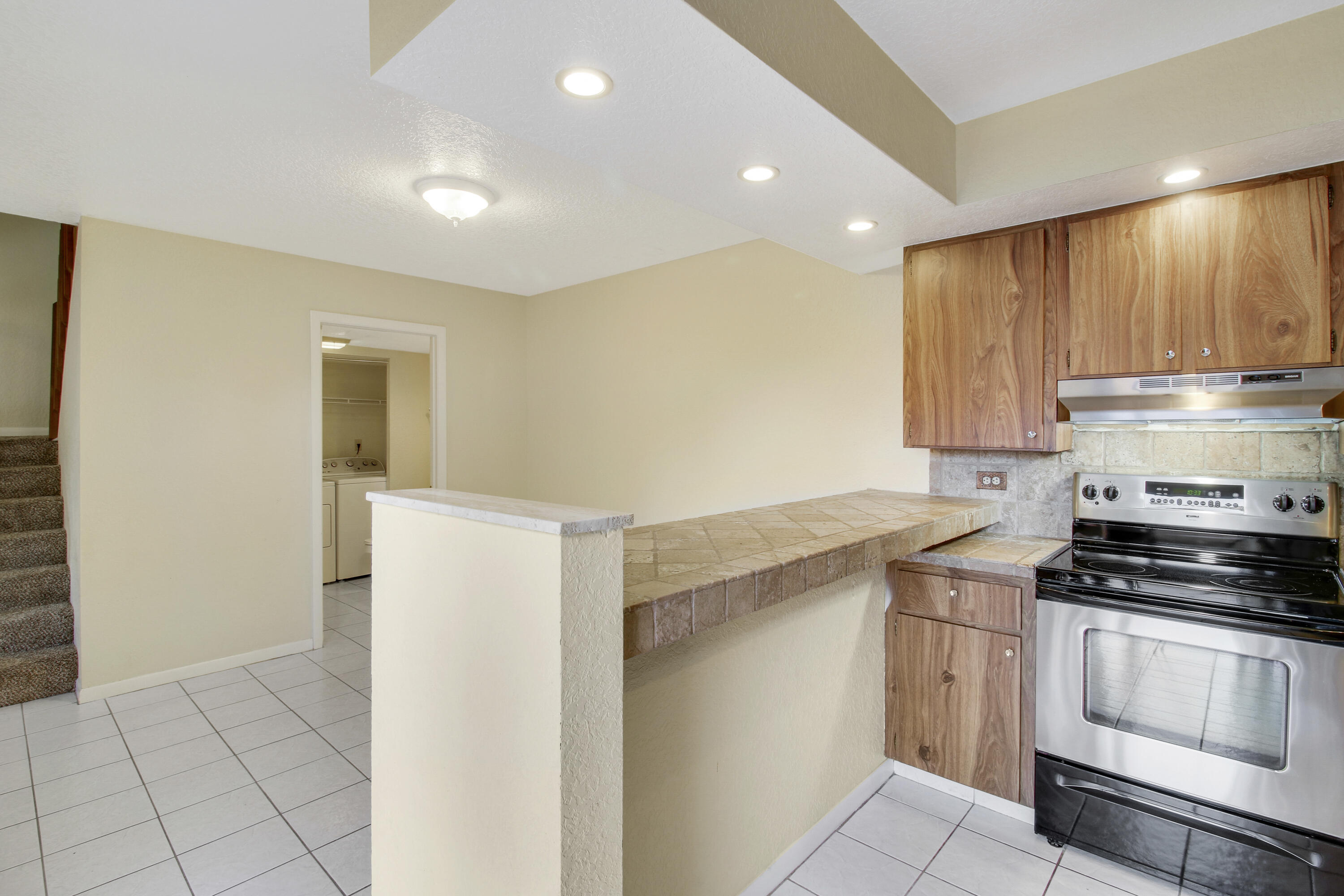 3900 County Line Road, Unit 21D Tequesta, FL 33469 - Photo 11 of 20 a kitchen with a stove and a refrigerator