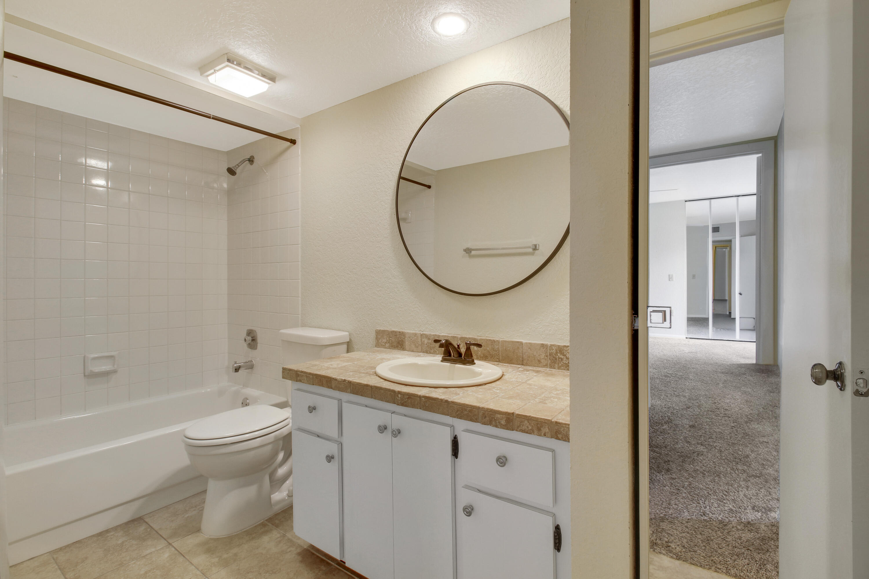 3900 County Line Road, Unit 21D Tequesta, FL 33469 - Photo 15 of 20 a bathroom with a sink a toilet and a mirror