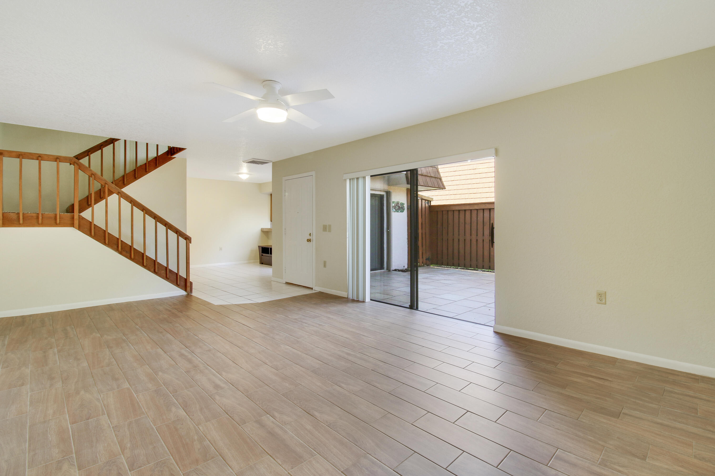 3900 County Line Road, Unit 21D Tequesta, FL 33469 - Photo 6 of 20 a view of an empty room with wooden floor