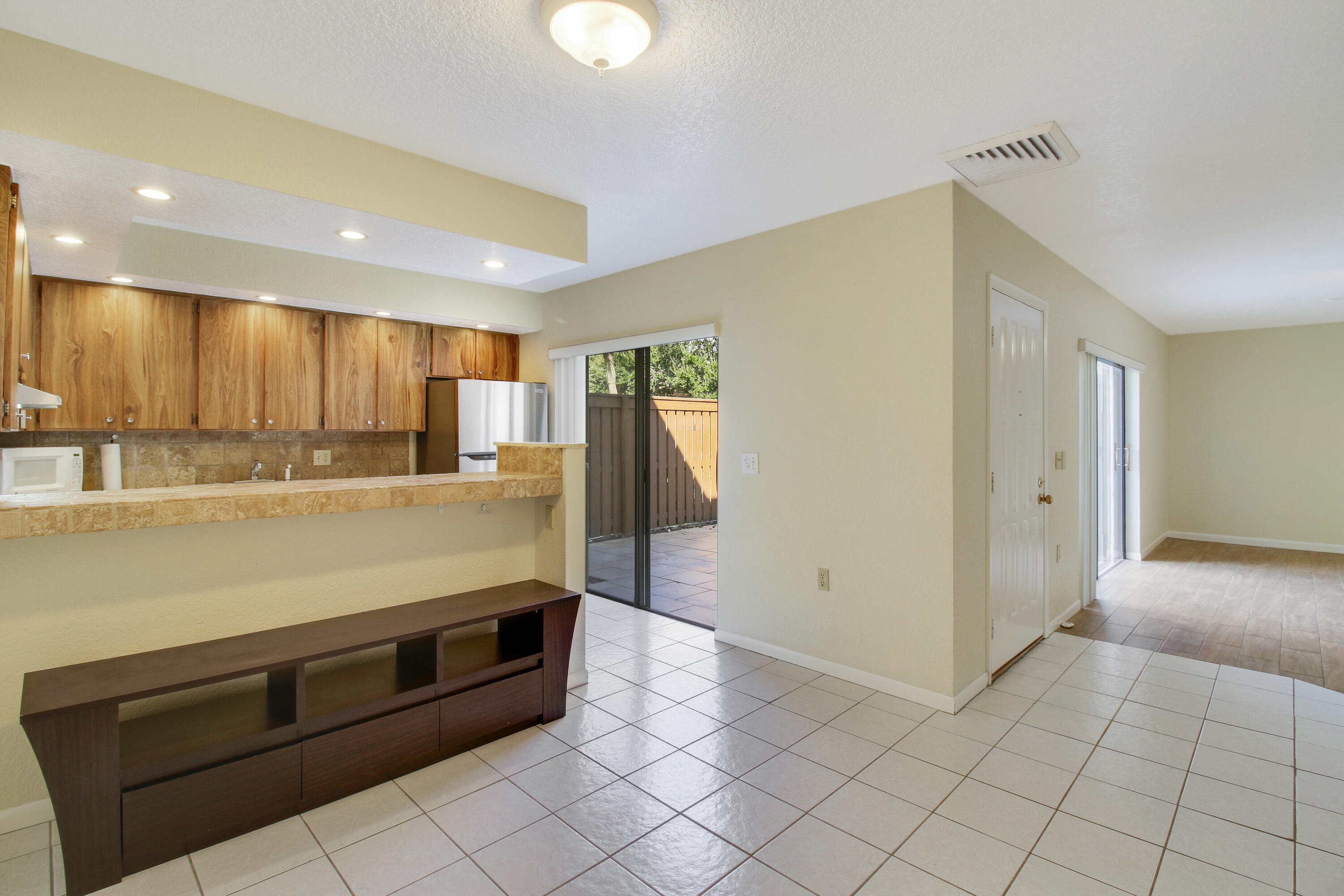 3900 County Line Road, Unit 21D Tequesta, FL 33469 - Photo 8 of 20 a large kitchen with stainless steel appliances granite countertop a refrigerator and a stove