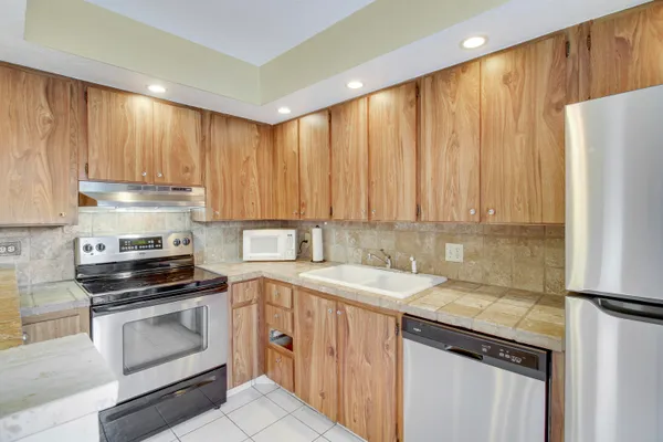 a kitchen with a stove top oven and cabinets
