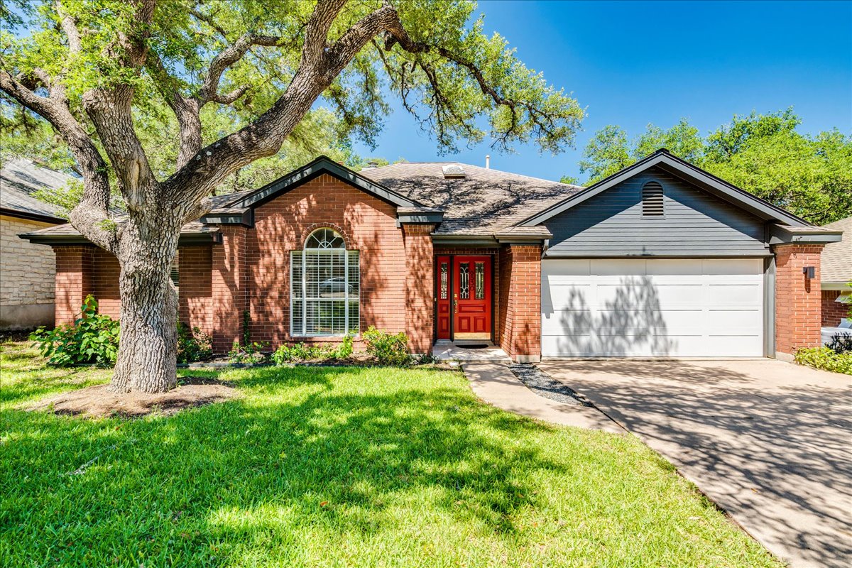 6530 Needham Lane Austin, TX 78739 - Photo 1 of 29 A classic brick exterior with an inviting red door and attached garage creates welcoming curb appeal.