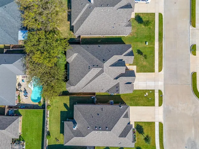 an aerial view of a house with a yard