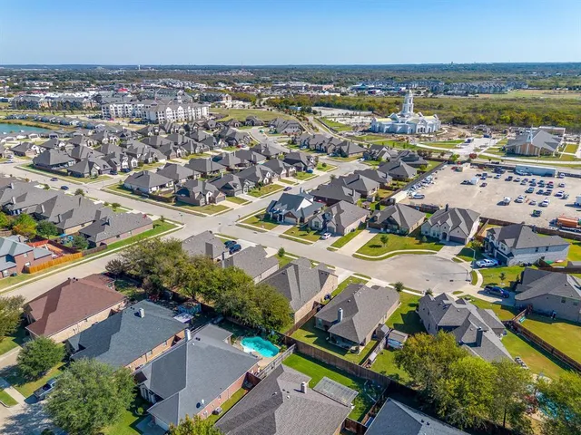 an aerial view of residential building and lake