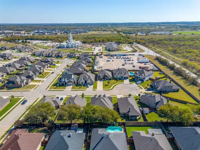 an aerial view of residential houses with outdoor space and swimming pool
