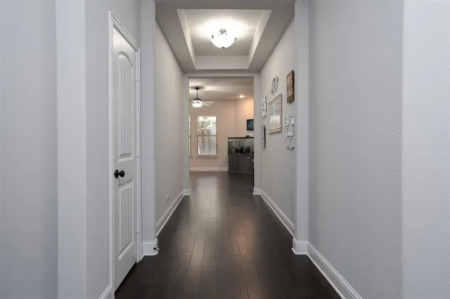 a view of a hallway with wooden floor