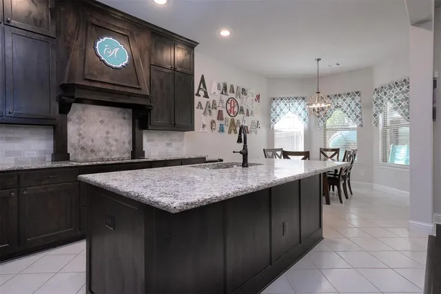 a kitchen with cabinets and chairs in it