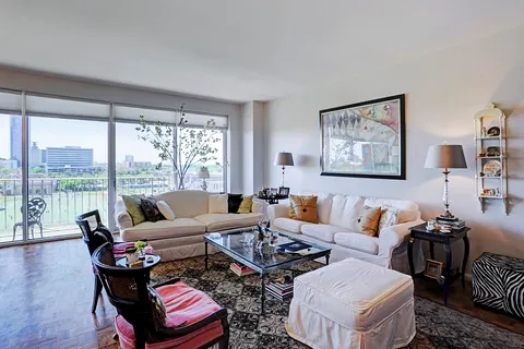 a living room with furniture and a floor to ceiling window