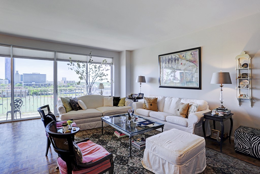 2200 Willowick Road, Unit 7B Houston, TX 77027 - Photo 11 of 32 a living room with furniture and a floor to ceiling window