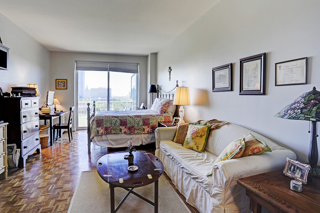2200 Willowick Road, Unit 7B Houston, TX 77027 - Photo 13 of 27 a living room with furniture and wooden floor